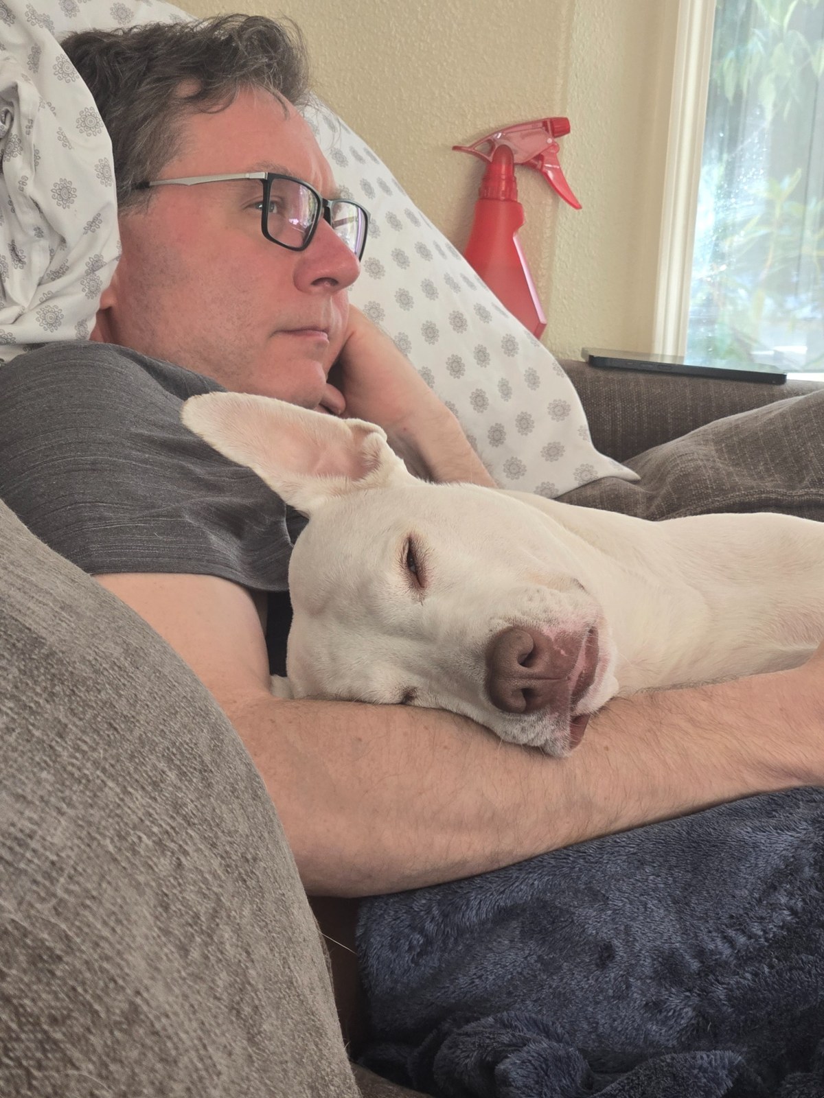 Me relaxing with our white dog